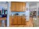 Bright kitchen featuring wooden cabinets, granite countertops, and access to an adjacent dining area at 270 Polk Rd, Covington, GA 30014