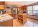 Bright kitchen features stainless steel appliances, wooden cabinets, granite counters, and a functional wooden island at 270 Polk Rd, Covington, GA 30014