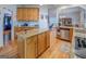 Well-lit kitchen featuring hardwood floors, granite countertops, and an island with ample cabinet space for storage at 270 Polk Rd, Covington, GA 30014