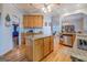 Open kitchen concept featuring an island with granite countertop, wooden cabinets, and hardwood floors at 270 Polk Rd, Covington, GA 30014
