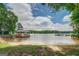 Sandy beach leading to calm lake waters with a covered dock at 270 Polk Rd, Covington, GA 30014