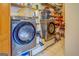 Utility room equipped with modern washer and dryer, ample storage shelving, and organized space for laundry essentials at 270 Polk Rd, Covington, GA 30014