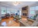 Cozy living room featuring a stone fireplace, hardwood floors, and lots of natural light at 270 Polk Rd, Covington, GA 30014