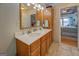 Main bathroom featuring double sinks, a large mirror, and access to the main bedroom at 270 Polk Rd, Covington, GA 30014