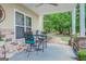 Covered patio with stone accents, featuring a dining set and serene views of the backyard at 270 Polk Rd, Covington, GA 30014