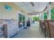 Covered patio with outdoor kitchen, bar seating, and views of the landscaped backyard and lake at 270 Polk Rd, Covington, GA 30014