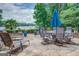 A lovely stone patio overlooking the lake with an outdoor dining table and umbrella, perfect for entertaining at 270 Polk Rd, Covington, GA 30014