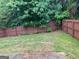 Fenced backyard with healthy green grass, plants, and plenty of shade from the trees at 11755 Lovejoy Crossing Blvd, Hampton, GA 30228