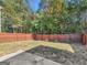 Fenced backyard with healthy green grass, plants, and plenty of shade from the trees at 11755 Lovejoy Crossing Blvd, Hampton, GA 30228