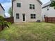 Back of house with a small patio, a fenced-in yard, and grass at 11755 Lovejoy Crossing Blvd, Hampton, GA 30228