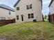 Back of house with a door, A/C, fenced-in yard, and grass at 11755 Lovejoy Crossing Blvd, Hampton, GA 30228
