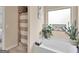This bathroom features a soaking tub, a window with plants, and a shower with a decorative curtain at 11755 Lovejoy Crossing Blvd, Hampton, GA 30228