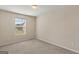 Cozy bedroom with neutral carpet, natural light from the window, and fresh paint at 11755 Lovejoy Crossing Blvd, Hampton, GA 30228