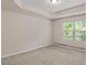 Bright bedroom featuring plush carpeting, a trey ceiling, and large windows at 11755 Lovejoy Crossing Blvd, Hampton, GA 30228