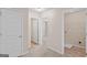 This hallway provides access to the laundry room and another bedroom, showcasing the home's practical layout at 11755 Lovejoy Crossing Blvd, Hampton, GA 30228