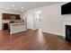 Open concept living area with kitchen island, stainless appliances, and hardwood floors at 11755 Lovejoy Crossing Blvd, Hampton, GA 30228