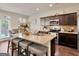 Gourmet kitchen features a large kitchen island with barstool seating and stainless steel appliances at 11755 Lovejoy Crossing Blvd, Hampton, GA 30228