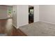 This living room offers open access to the dining and kitchen areas, with a mix of carpet and hardwood flooring at 11755 Lovejoy Crossing Blvd, Hampton, GA 30228