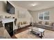 Comfortable living room with a fireplace, plush seating, and natural light from a large window at 11755 Lovejoy Crossing Blvd, Hampton, GA 30228