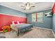Well-lit bedroom with two-toned walls, carpet flooring, and a ceiling fan at 790 Riverwood Pass, Dallas, GA 30157