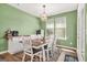 Inviting dining room with a modern light fixture and views of the yard at 790 Riverwood Pass, Dallas, GA 30157