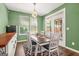 Inviting dining room featuring a modern light fixture and access to outdoor spaces at 790 Riverwood Pass, Dallas, GA 30157