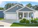 Charming blue home with white trim, a welcoming porch, and a well-manicured lawn at 790 Riverwood Pass, Dallas, GA 30157