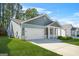 Charming home showcasing a two-car garage, covered porch, and green lawn at 790 Riverwood Pass, Dallas, GA 30157