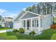 Charming blue home featuring a covered porch, manicured lawn, and white trim at 790 Riverwood Pass, Dallas, GA 30157