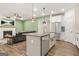 Island kitchen offering stainless appliances and an open floor plan to the living area at 790 Riverwood Pass, Dallas, GA 30157