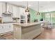 Open kitchen boasts a large island, stainless appliances, and stylish pendant lighting at 790 Riverwood Pass, Dallas, GA 30157