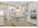 Bright kitchen featuring stainless steel appliances, an island, and modern lighting fixtures at 790 Riverwood Pass, Dallas, GA 30157
