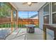 Relaxing screened porch with wood ceiling, ceiling fan, and outdoor fire pit at 790 Riverwood Pass, Dallas, GA 30157