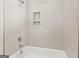 Shower area featuring light tile surround, complete with a convenient niche and modern fixtures at 790 Riverwood Pass, Dallas, GA 30157