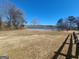 Expansive backyard with clear skies, trees, and lake views at 222 Flat Creek Ct, Peachtree City, GA 30269