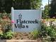 A welcoming community sign surrounded by lush greenery and colorful flowers in a well maintained setting at 222 Flat Creek Ct, Peachtree City, GA 30269