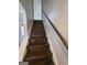Wooden staircase features white risers, neutral walls, and a handrail for a classic and safe design at 222 Flat Creek Ct, Peachtree City, GA 30269