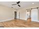 Spacious bedroom with barn door access to the ensuite bathroom, featuring hard wood floors at 4711 H D Atha Rd, Covington, GA 30014