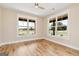 Bright, large bedroom with ample natural light from the well-lit windows and hardwood floors at 4711 H D Atha Rd, Covington, GA 30014