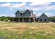 Charming two-story farmhouse with a welcoming front porch and large front yard at 4711 H D Atha Rd, Covington, GA 30014