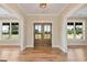 Welcoming foyer with double doors and views to the front yard through large windows at 4711 H D Atha Rd, Covington, GA 30014