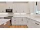 Modern kitchen features white cabinets and countertops, and stainless steel appliances at 4711 H D Atha Rd, Covington, GA 30014