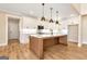 Bright, modern kitchen with white cabinets, a center island, and stainless steel appliances at 4711 H D Atha Rd, Covington, GA 30014