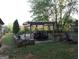Backyard with a pergola-covered patio, raised garden beds and a firepit, perfect for outdoor entertaining at 1253 Heartwood Ave, Mcdonough, GA 30253
