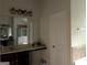 Bathroom featuring double sinks, large mirror, and enclosed shower, creating a serene and luxurious experience at 1253 Heartwood Ave, Mcdonough, GA 30253