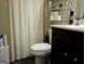 This bathroom features a toilet and sink with vanity space and storage at 1253 Heartwood Ave, Mcdonough, GA 30253