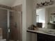 Elegant bathroom features a glass-enclosed shower and a spacious vanity with a stylish mirror at 1253 Heartwood Ave, Mcdonough, GA 30253