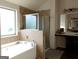 Bathroom showcasing a soaking tub, separate glass-enclosed shower, and dual sink vanity with great lighting at 1253 Heartwood Ave, Mcdonough, GA 30253