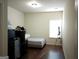 Simple bedroom with laminate floors and ample natural light at 1253 Heartwood Ave, Mcdonough, GA 30253