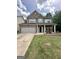 Charming two-story brick home featuring a two-car garage and a well-manicured front lawn at 1253 Heartwood Ave, Mcdonough, GA 30253